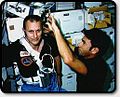 STS-5 Lenoir cuts Overmyer's hair.jpg